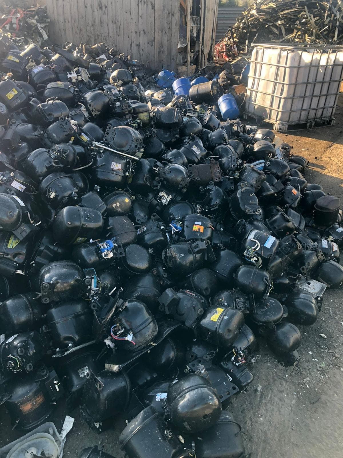 Outdoor stockpile of scrap compressors ready for grading and processing